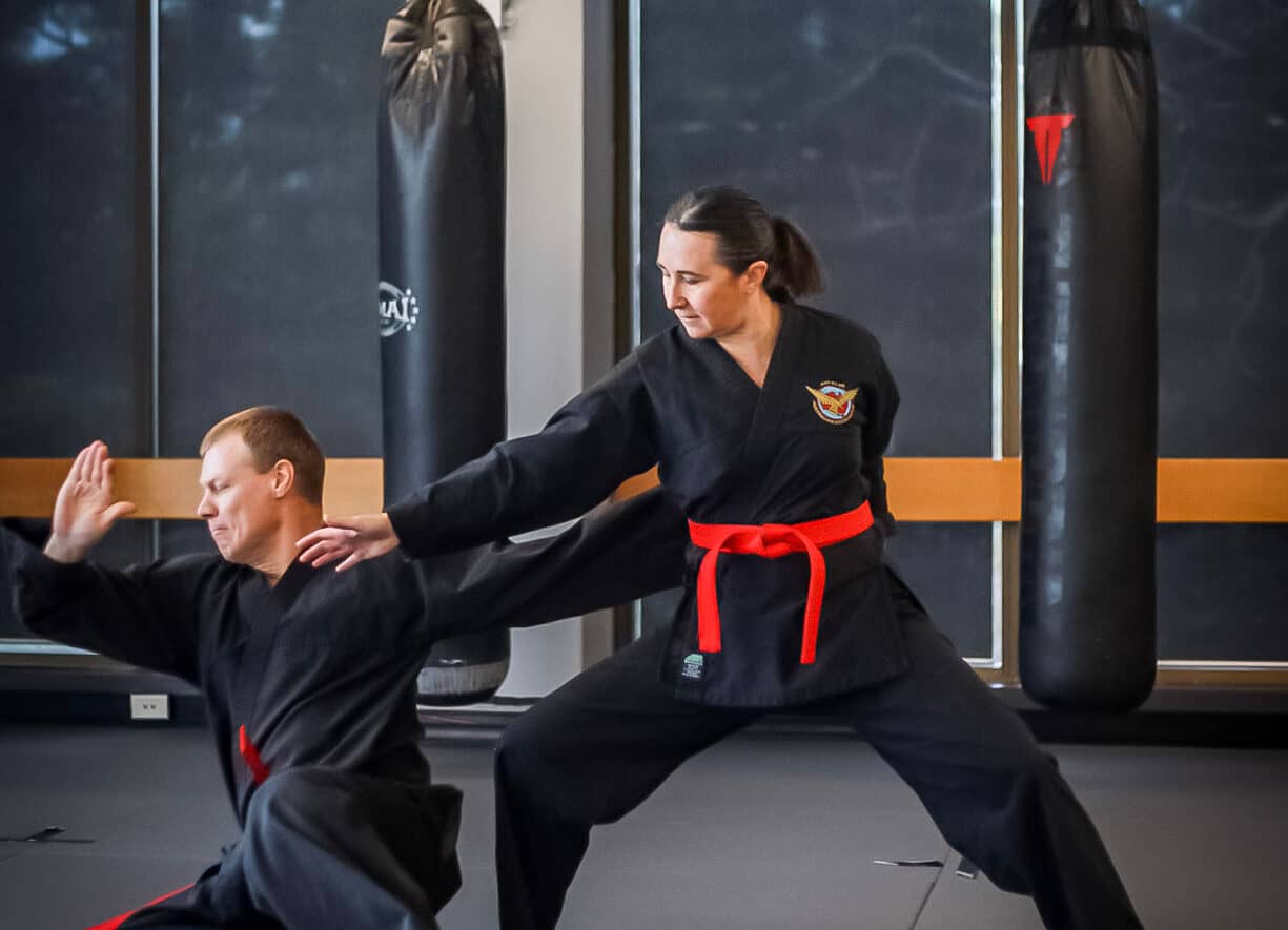 woman defending herself in a martial arts stance looking powerful and balanced