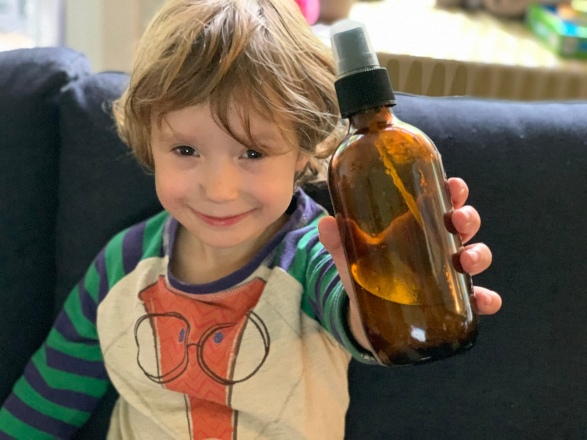 boy holding bottle of natural insect repellent